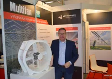 Peter van der Putten of Vostermans Ventilation is standing next to their Multifan.